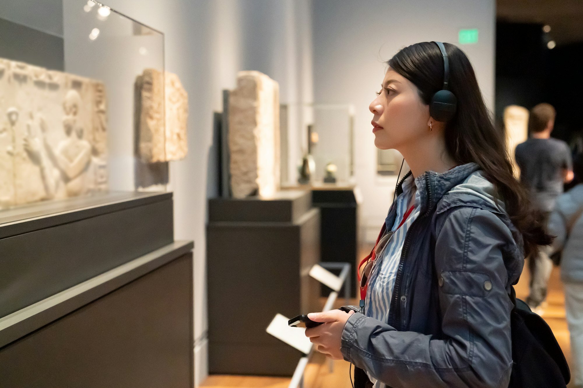girl taking audio tour in the history museum
